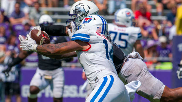 TCU Horned Frogs linebacker Namdi Obiazor (4) breaks up a pass intended for SMU Mustangs tight end Nolan Matthews-Harris (14) during the second half at Amon G. Carter Stadium. 